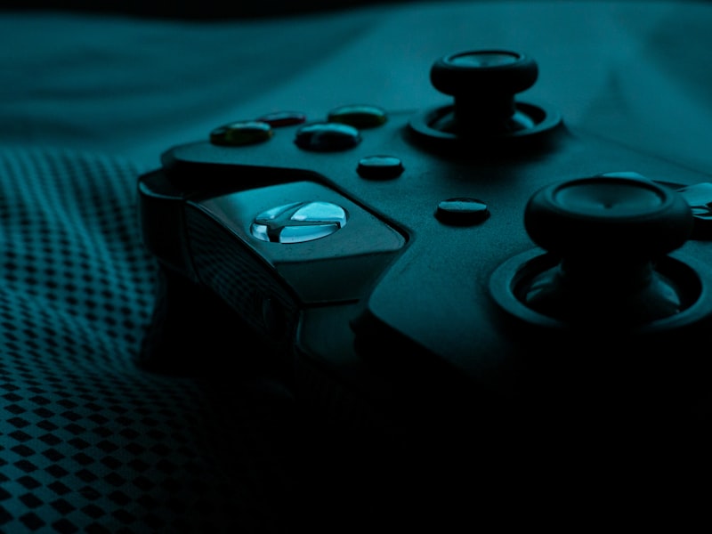 A worn desk with parchment maps, dice, and a steaming cup at dusk